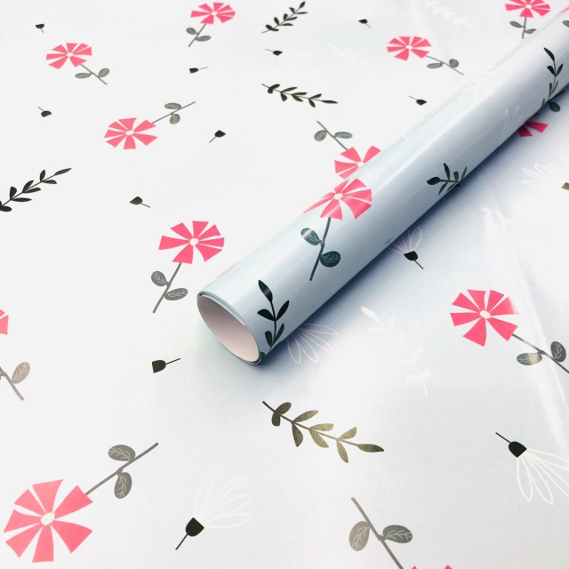 Premium glossy art paper featuring vibrant five-color floral patterns for elegant gift wrapping.