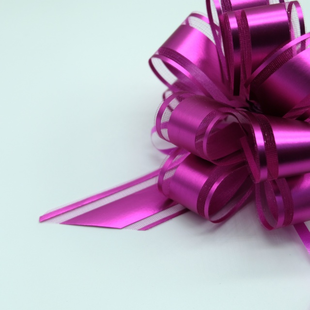 Soft gauze pom bows with delicate texture for elegant gift decoration.